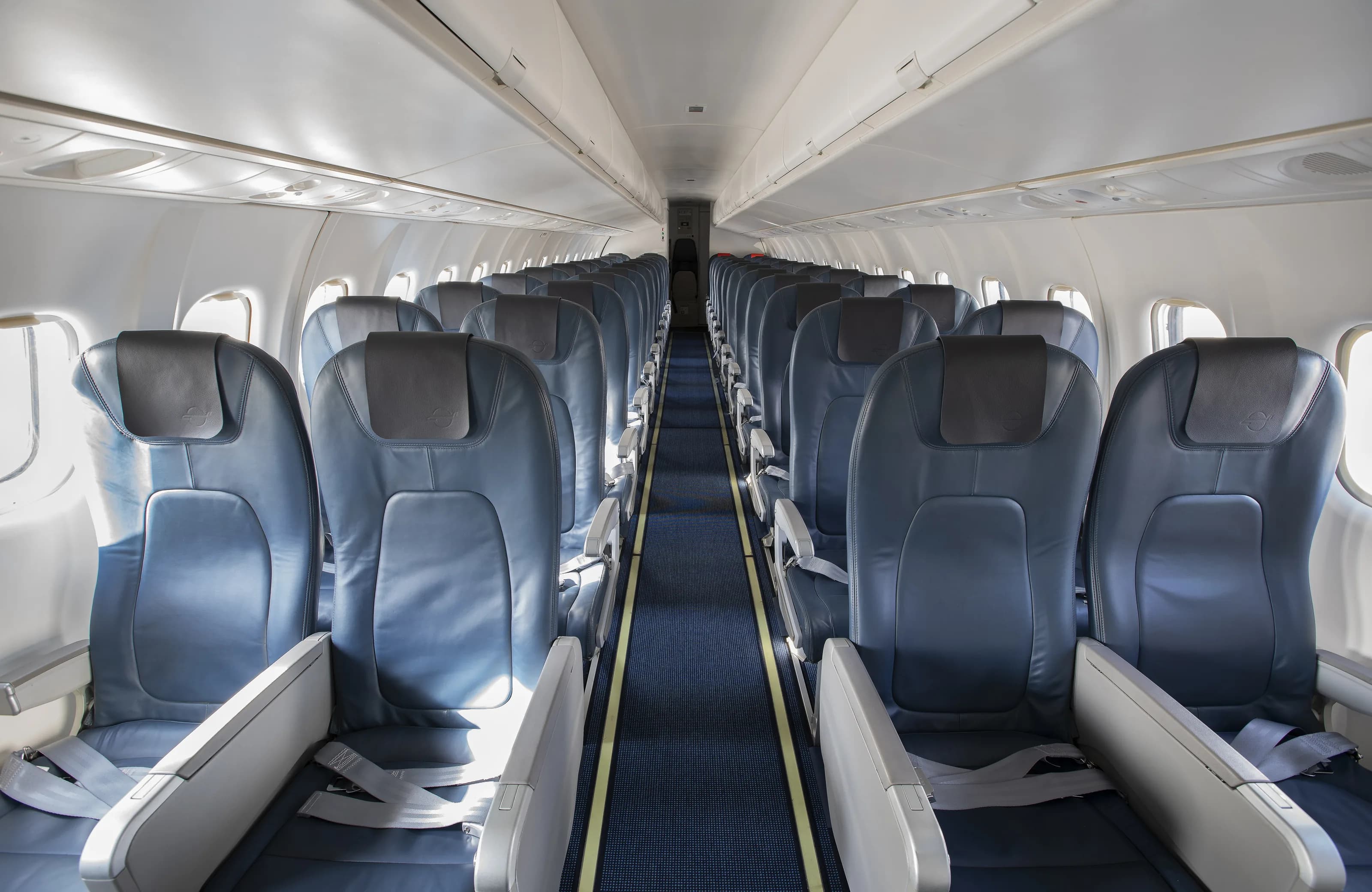 The cabin of the ATR 42-500: blue leather seats, overhead bins