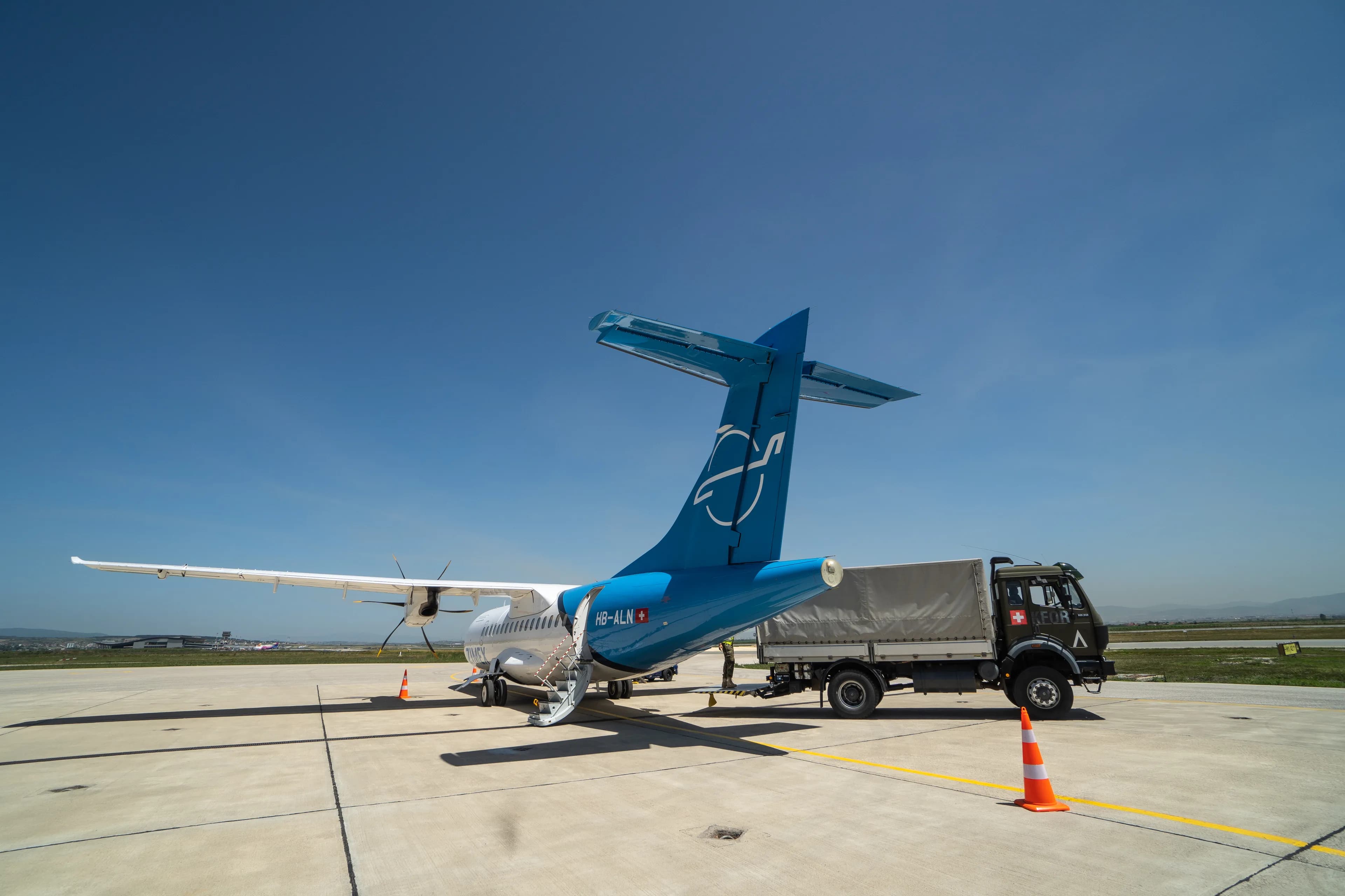 The Zimex ATR 42 on the apron at Pristina, with a military truck alongside