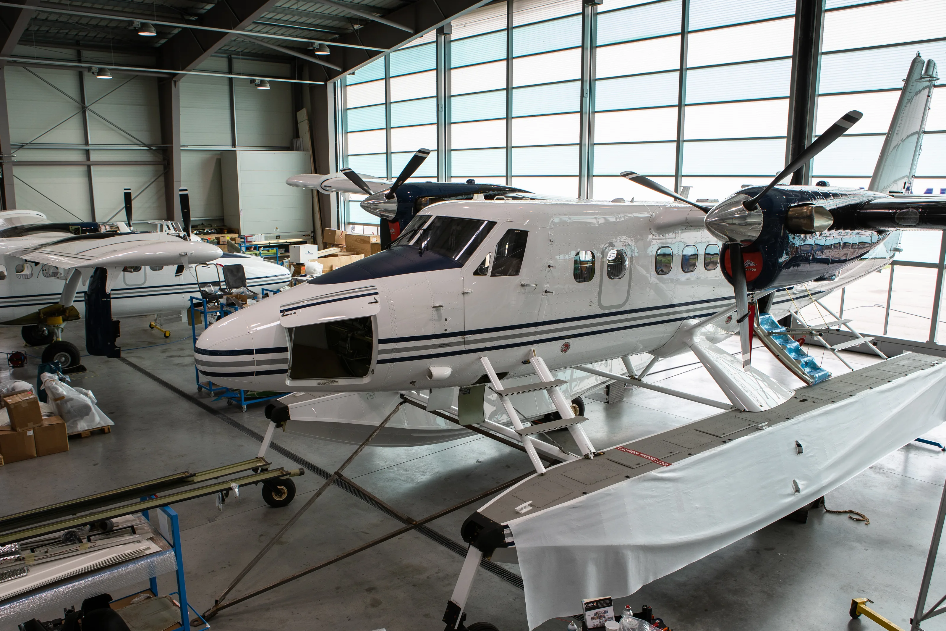 A Twin Otter on floats in the Zimex hangar at Altenrhein, under the hangar roof
