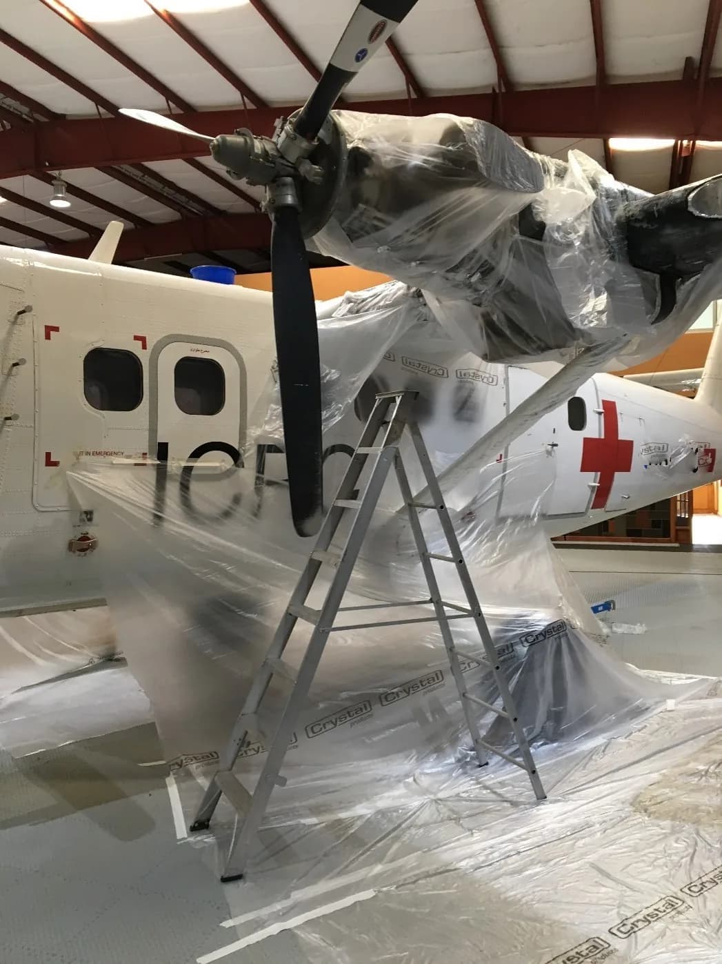 ICRC Twin Otter masked in plastic sheeting before painting
