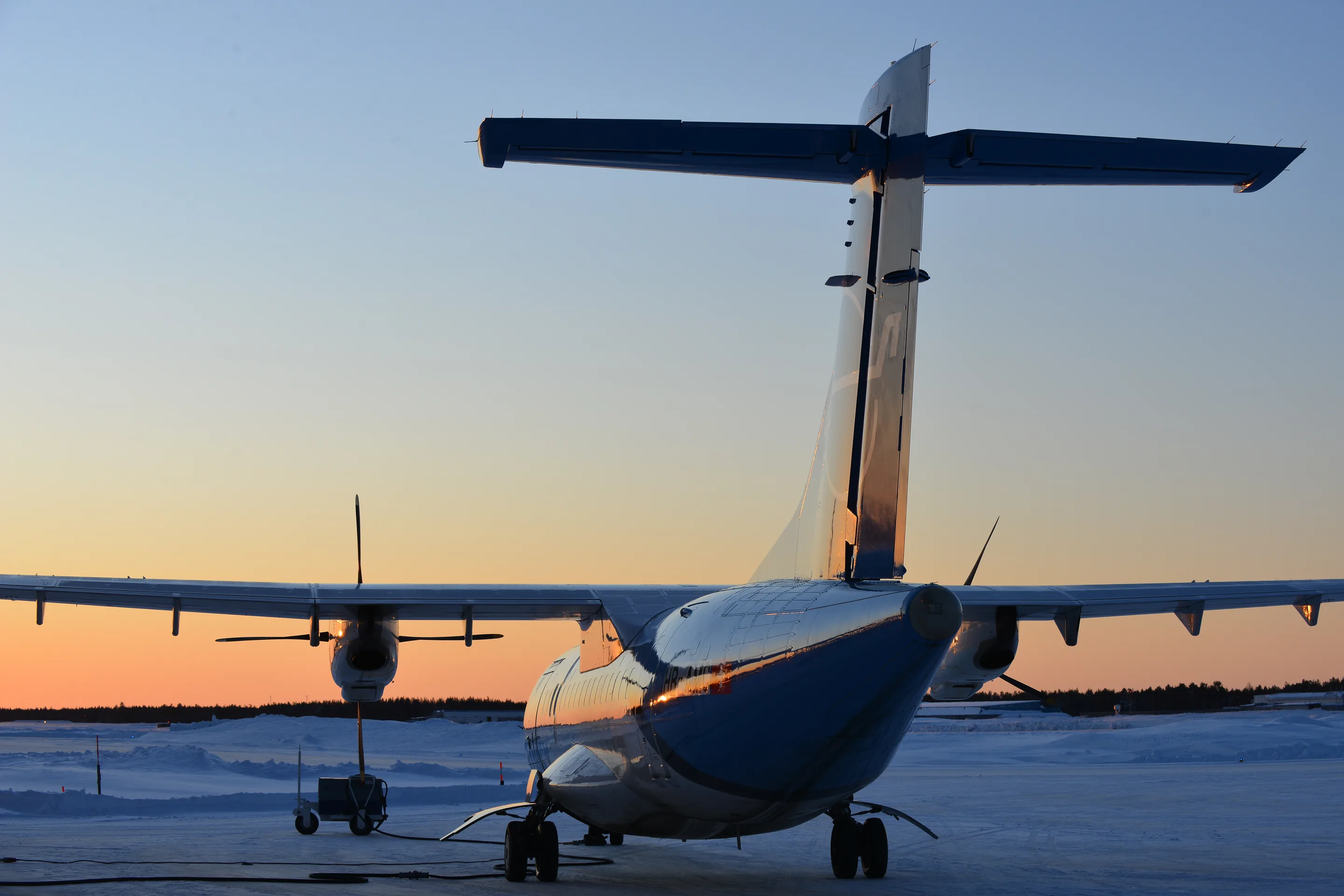 An ATR freighter on a snowy apron in Sweden at dusk