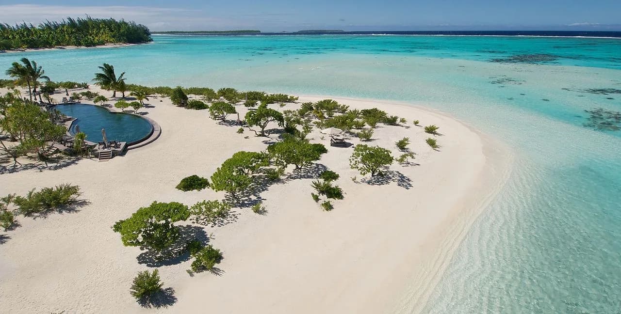 Tetiaroa atoll from the air: white sand, a lagoon pool and palms